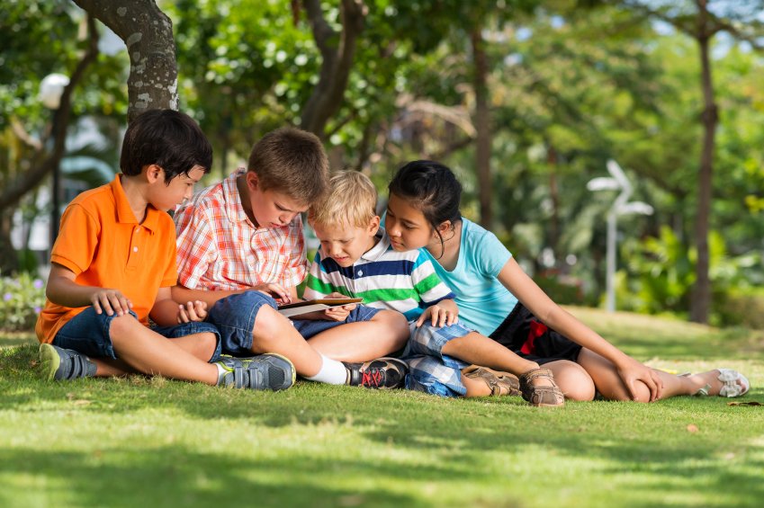 Group of children sitting on the grass