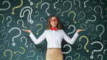 Business woman with question mark on a blackboard