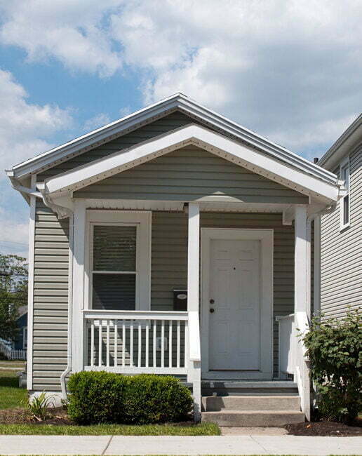A very small, gray house that has been renovated.