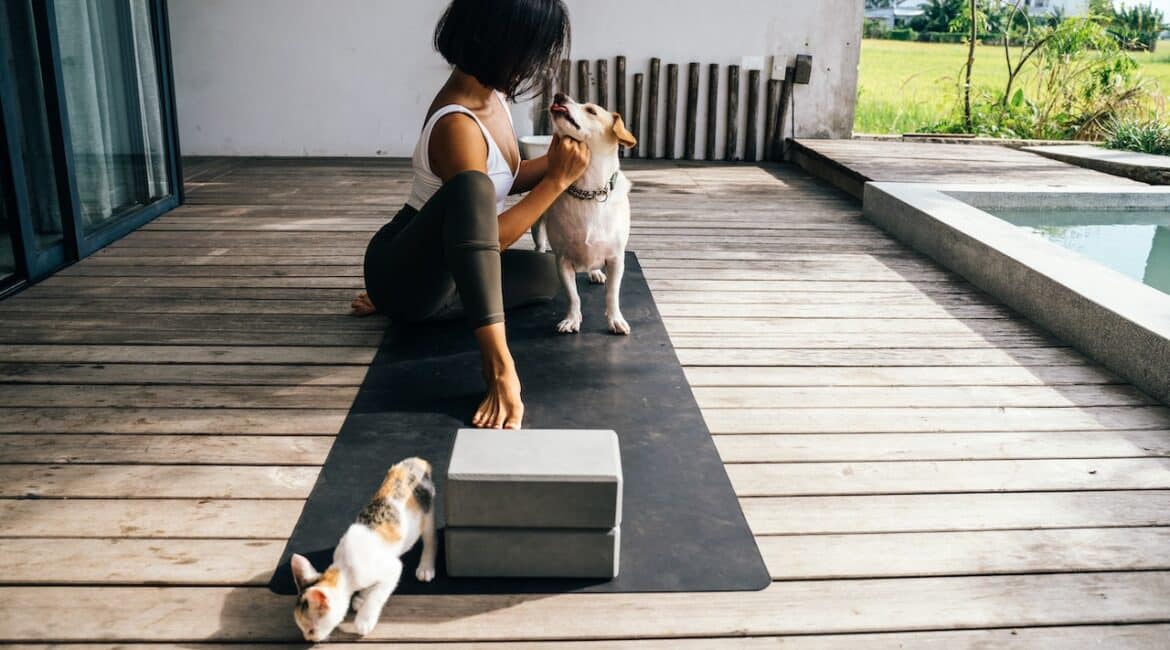 woman working out outside with pets