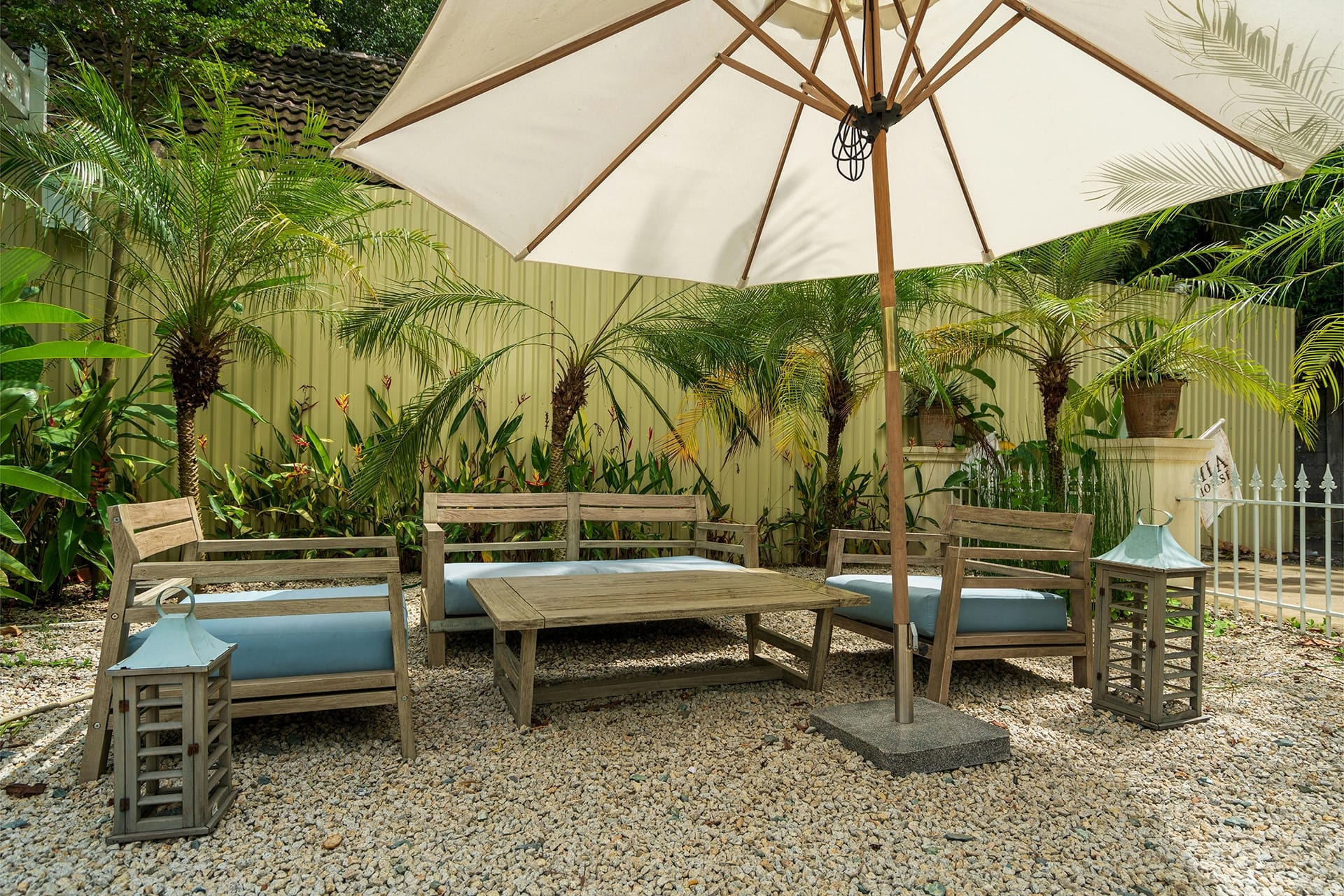 Tropical garden patio with hurricane-ready wooden seating in Florida