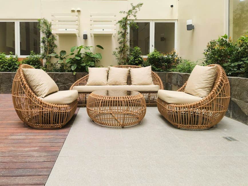 All-weather resin wicker conversation set with neutral gray cushions on a Florida townhouse patio