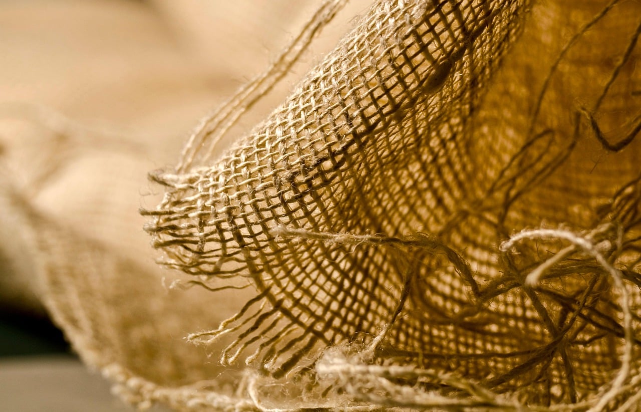 Close-up of aluminum sling chair fabric showing UV-resistant weave texture near a pool