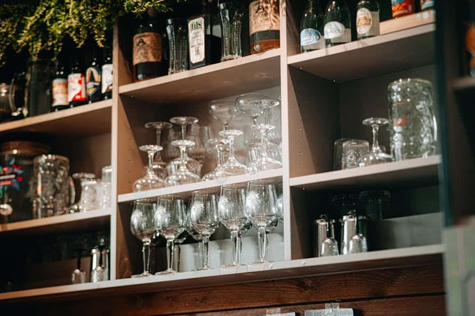 Outdoor bar storage cabinet and acrylic glassware display in a Florida patio setting