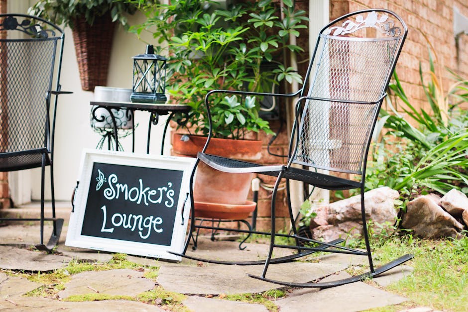 Outdoor patio setup with smoker station and powder-coated aluminum furniture in a Florida backyard
