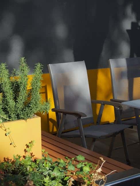 Side-by-side comparison of white and dark powder-coated aluminum patio chairs on a Florida patio