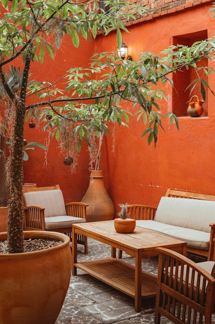 Stamped concrete patio with warm terracotta tones and bronze powder-coated aluminum outdoor furniture