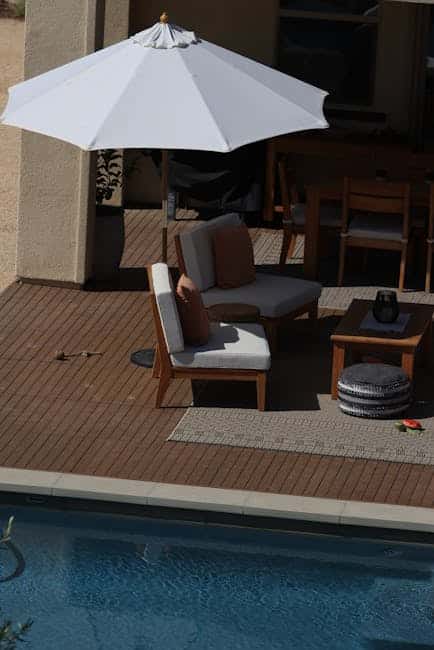 Two modular loveseats arranged around an outdoor coffee table on a Florida pool deck