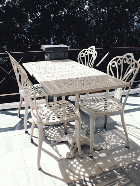 White powder-coated aluminum patio chairs and table on a sunny Florida lanai